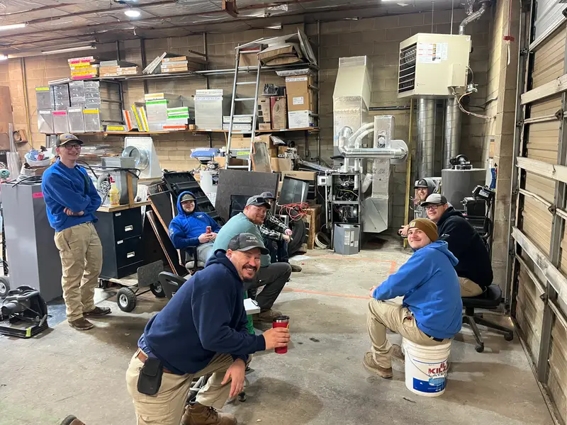 The Affordable Air team relaxing together in the shop between jobs